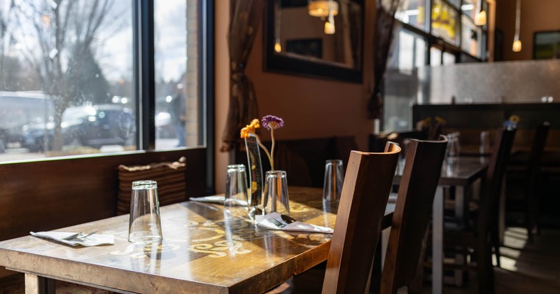 Interior, set tables and chairs next to the window