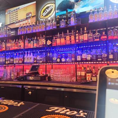 Interior, liquor bottles on bar shelves.