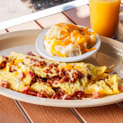 Omelet with ham, sausage, bacon, and cheese.