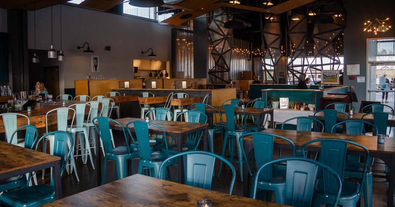 Interior, tables with chairs, bar on the left, restaurant entrance on the right