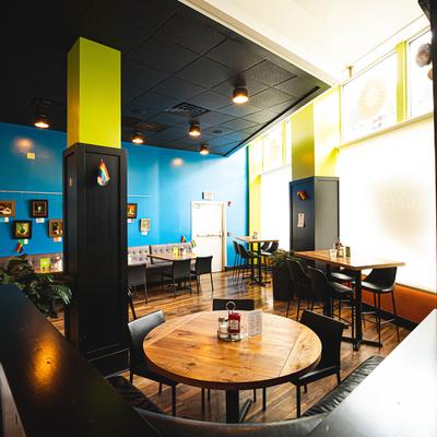 Interior, blue wall with pictures in the back.