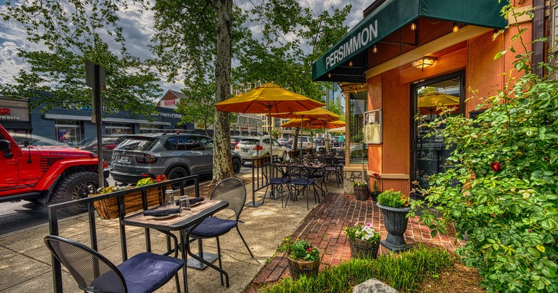 Exterior, restaurant front, partially covered seating area, tables under parasols