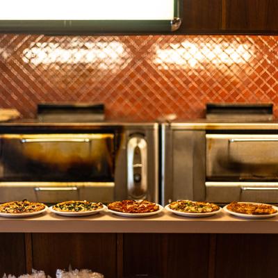 Interior, Different pizza plates served on a counter