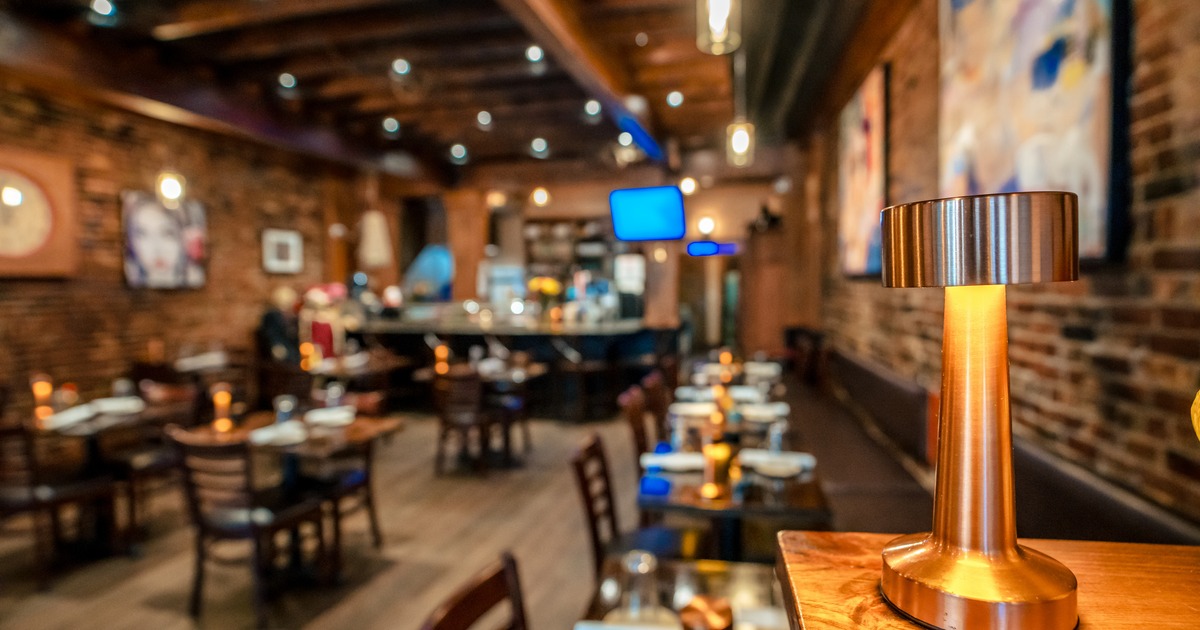 Diner area, wide, view, tables, chairs, bar behind, tv screens above
