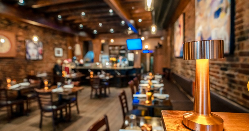 Diner area, wide, view, tables, chairs, bar behind, tv screens above