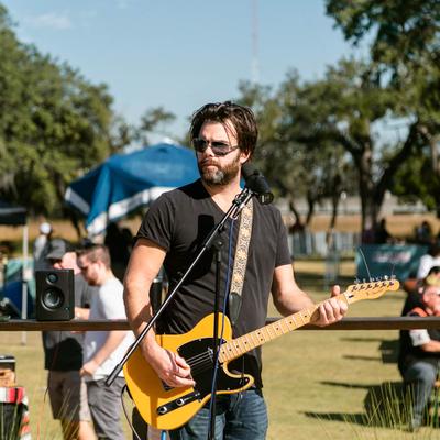 Outdoors, a musician performing.