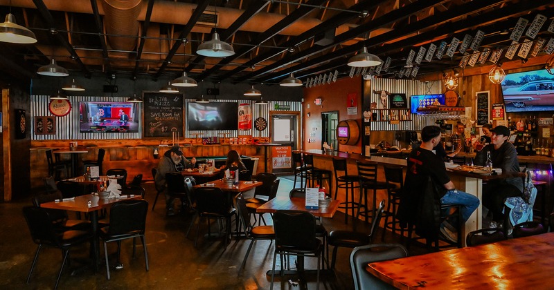 Interior space, bar and dining area, guests enjoying their food and drinks