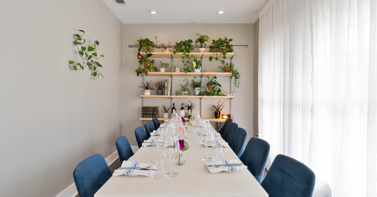 Table setting in front of a rack with plants