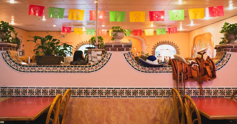 Decorated wall, diner tables and chairs