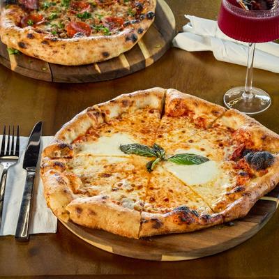 A freshly baked Pizza Margherita served on a table.