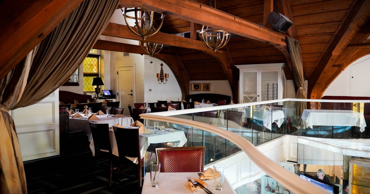 Interior, upstairs dining area, white cloth tables with chairs, ready for guests