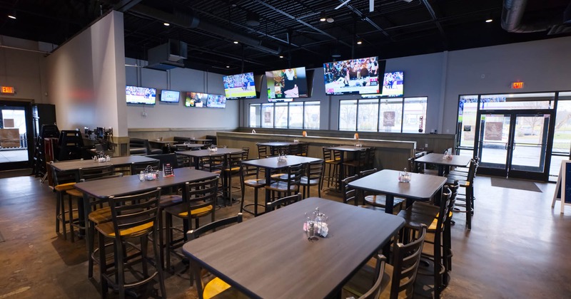 Interior, tall tables for four people, bar stools