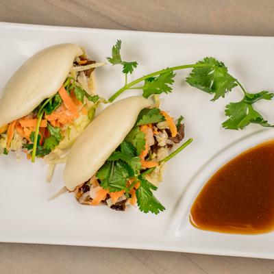 Buns stuffed with grilled beef, lettuce, mint, carrots, and radish.