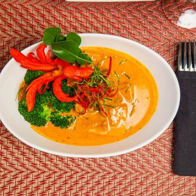 Panang Curry with broccoli and various garnishes.