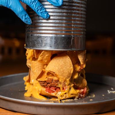 Bucket nachos being served on a plate.
