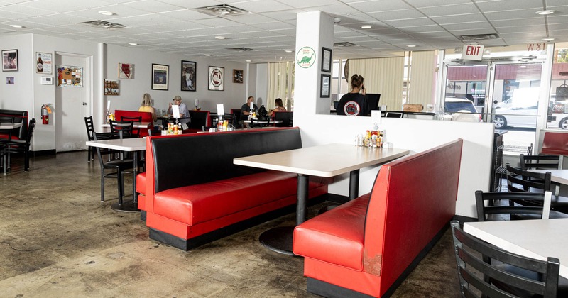 Interior, dining area with few guests in the back