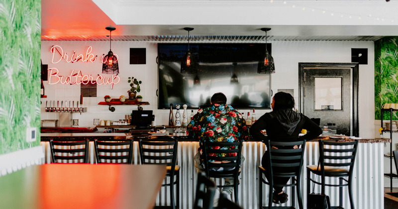 Interior, bar with two guests sitting