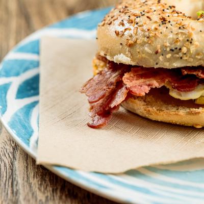 Breakfast bagel sandwich, with scrambled egg, bacon, and cheddar.