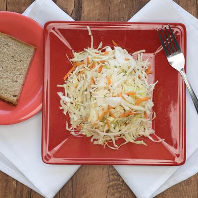 Coleslaw salad served with bread slice.