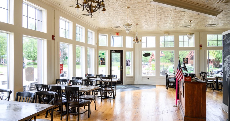 Interior view of a well-lit restaurant featuring wooden tables
