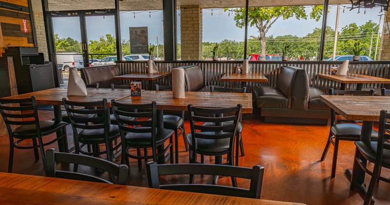 Interior, tables, chairs and leather benches ready for guests