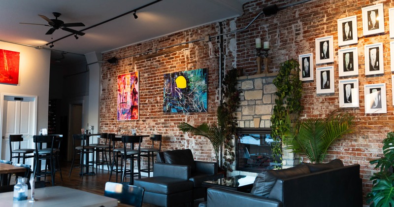 Interior, dining and lounge area, tables and chairs, sofa and armchair, fireplace