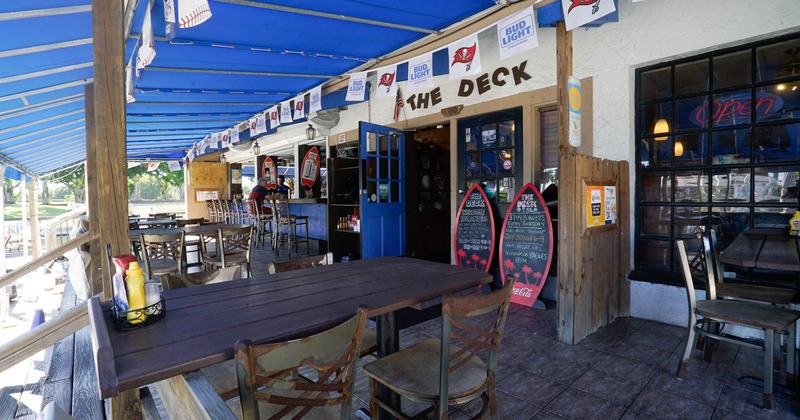 Exterior, patio, seating area, restaurant entrance, outdoor bar with bar stools