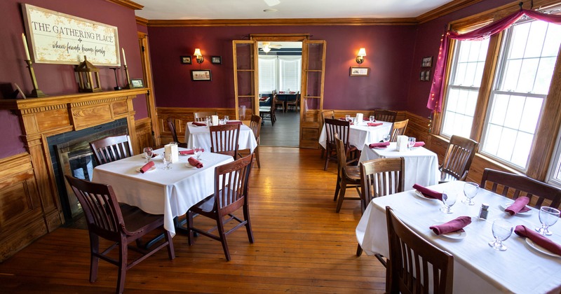 Interior, tables for four, stylish wooden chairs, various engraved wooden details