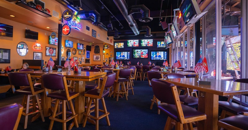 Interior, dining area, several TV's on the wall