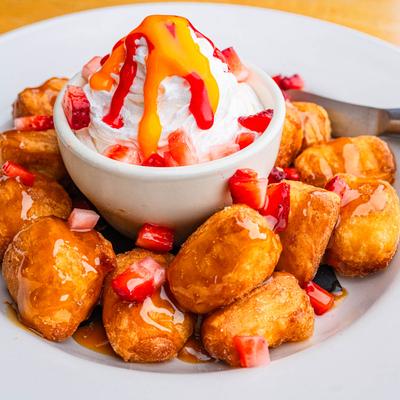 Campfire Donuts with creamy whipped icing and fresh diced strawberries.