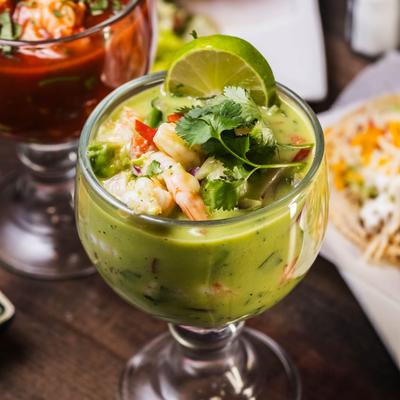 Mixed ceviche with shrimp cocktail behind it.