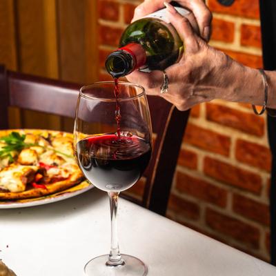Red wine being poured into a glass.
