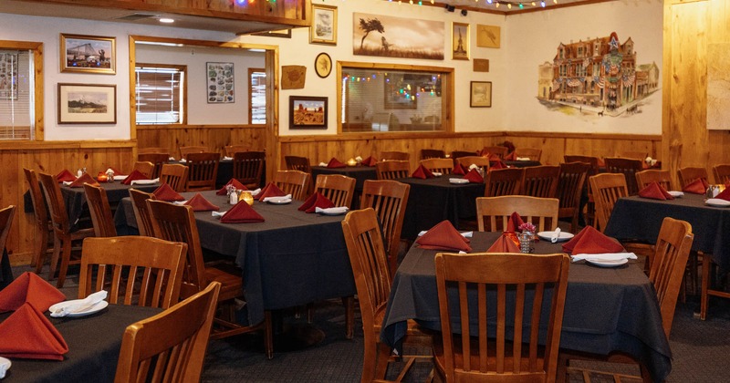 Restaurant interior, tables and chairs, paintings on the walls
