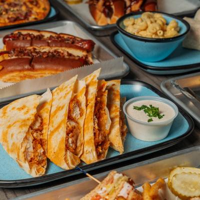 Grilled quesadilla wedges served with a cup of creamy dipping sauce.