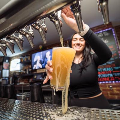 Bartender pouring beer from the tap.