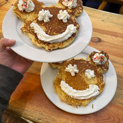 A hand serving desserts.