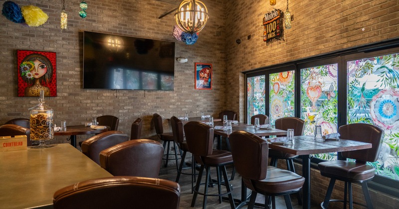Interior, seating area with leather chairs, brick walls