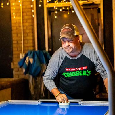 A person playing Air Hockey.