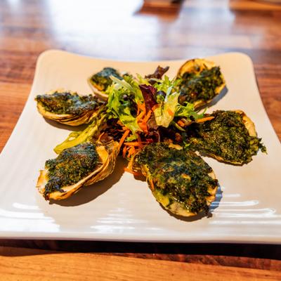 Rockefeller Oysters stuffed with spinach, parsley and parmesan.