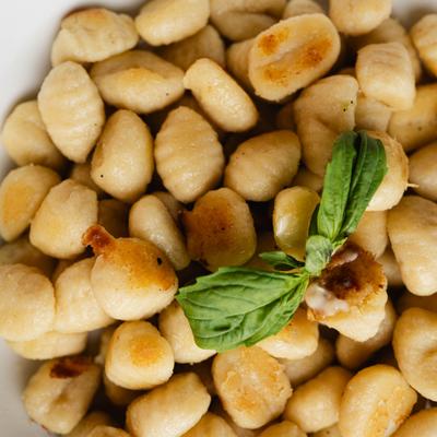 Potato gnocchi with basil garnish.