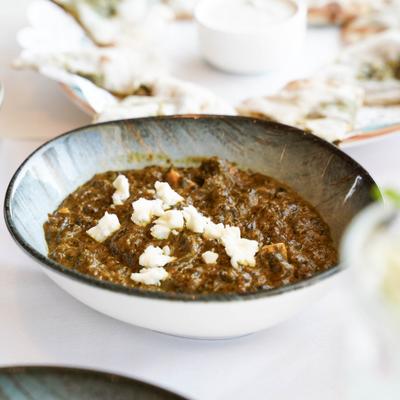 Spinach paneer served in a bowl.