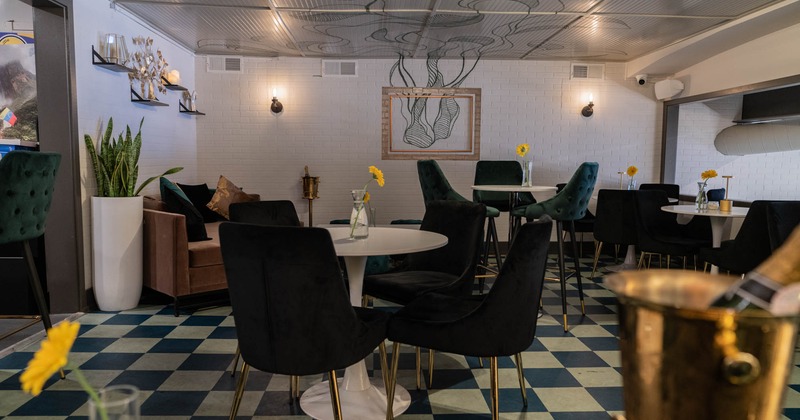Dining area with round tables and chairs, waiting for the guests