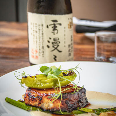 Grilled meat with green decorations on top closeup