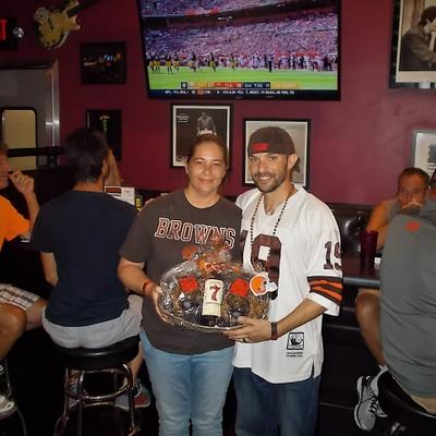 A guy and a girl with a present posing for a photo