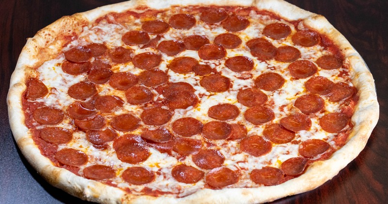 Pepperoni pizza served on a wooden table