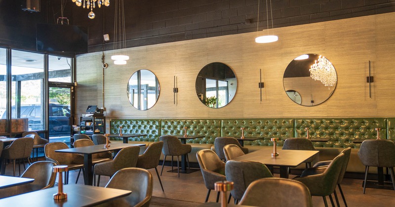 Interior, dining area, tables and chairs ready for guests, restaurant entrance