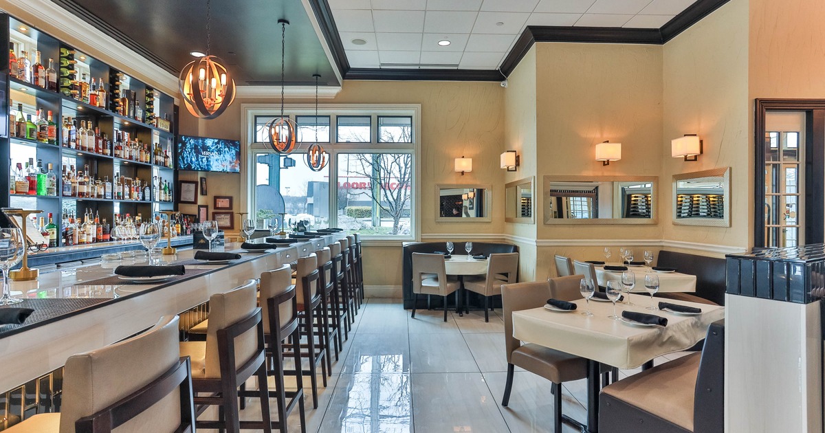 Interior, tables and chairs near bar
