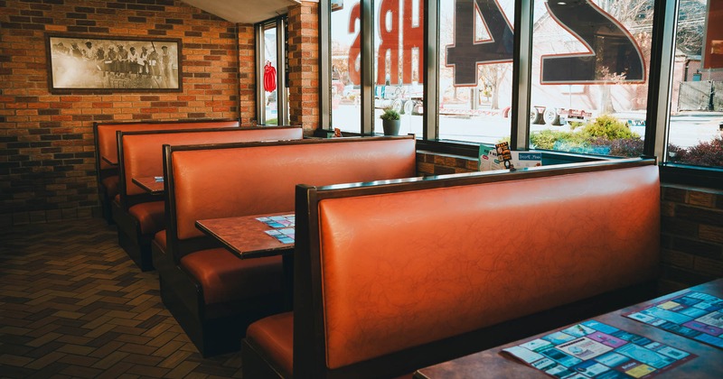 Dining area, restaurant booths lined up with the picture on the wall