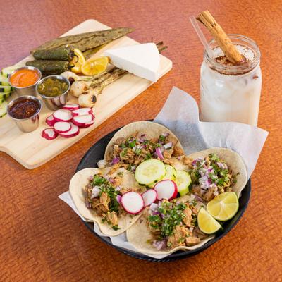 Pork tacos, Horchata, and veggies on the side.
