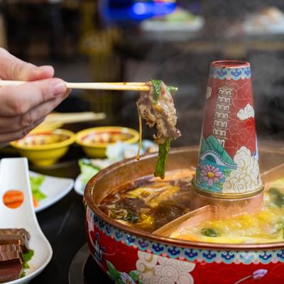 A person enjoying food from the Hot Pot.